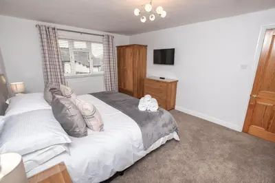 a bedroom with a large bed and a window at Manesty House - Rooms only - no kitchen-living in Keswick