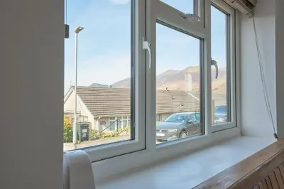 a window in a room with a view of a car at Manesty House - Rooms only - no kitchen-living in Keswick