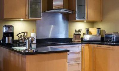 a kitchen with wooden cabinets and a counter top at Robinson in Keswick