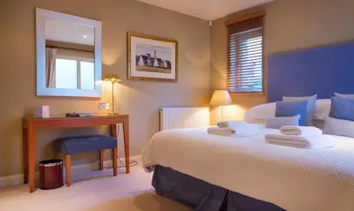a bedroom with a large bed with towels on it at Robinson in Keswick