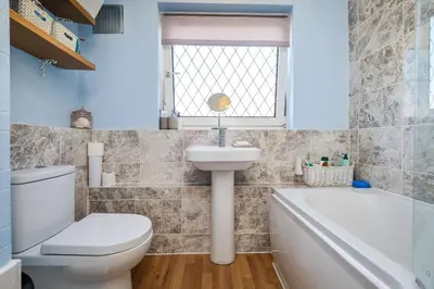 a bathroom with a toilet and a sink and a bath tub at Guild Close in Moffat
