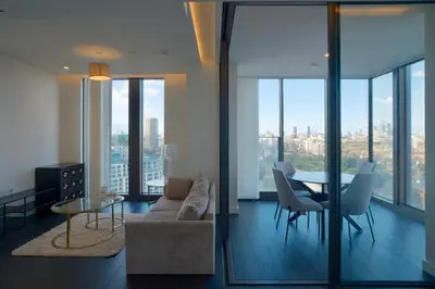 a living room with a couch and a table and chairs at 2b2b skyline flat&amazing view! in Moffat