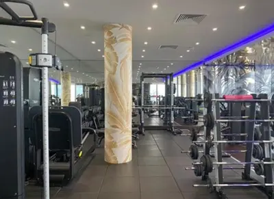 a gym with a column in the middle of a room at 2b2b skyline flat&amazing view! in Moffat
