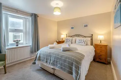 a bedroom with a bed and a window at 2 Bed in Allonby oc-i30743 in Allonby