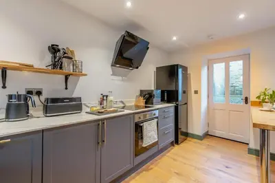 a kitchen with stainless steel appliances and a counter top at 3 Bed in Caldbeck oc-h30704 in Caldbeck