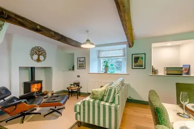 a living room with a couch and chairs and a fireplace at 3 Bed in Caldbeck oc-h30704 in Caldbeck