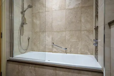 a bathroom with a shower with a glass door at Derwent in Keswick