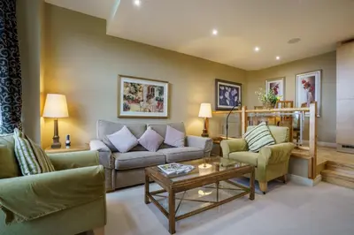 a living room with two couches and a coffee table at Derwent in Keswick