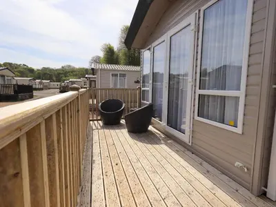 a wooden deck next to a house at Seren in Cockermouth