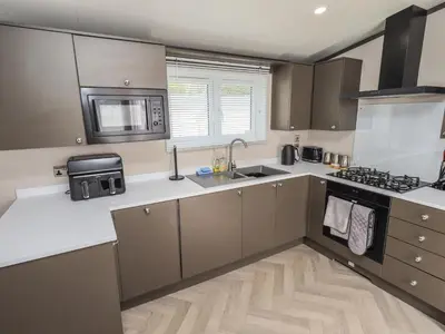 a kitchen with a sink and a stove at Haven in Cockermouth