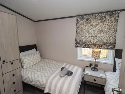 a small bedroom with a bed and a window at Haven in Cockermouth