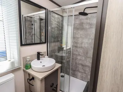 a bathroom with a sink and a shower at Haven in Cockermouth