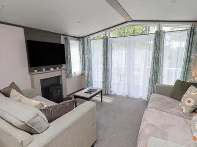 a living room with a couch and a fireplace at Haven in Cockermouth
