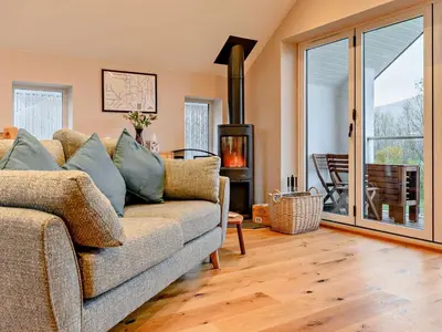 a living room with a couch and a fireplace at 3 Bed in Keswick oc-93589 in Threlkeld