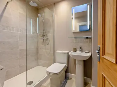 a bathroom with a toilet and a shower and a sink at 3 Bed in Keswick oc-93589 in Threlkeld