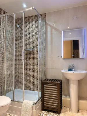 a bathroom with a shower and a sink and a toilet at Marina 2bedroom Beach Nearby Swansea City in Moffat