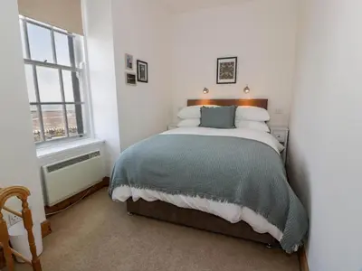 a bedroom with a bed and a window at 2Loos in Newton Stewart