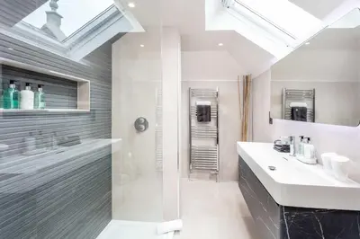 a bathroom with a glass shower and a sink at No36 South Beach - Donnini Apartments in Troon