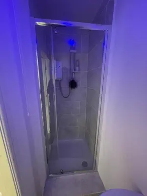 a bathroom with a shower with a bath tub at New Stylish Large 1-Bed Apartment - Close to Old Trafford & More in Moffat