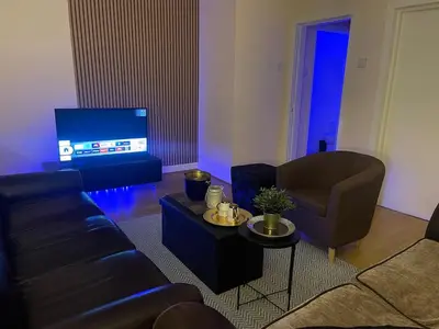 a living room with a couch and a chair and a tv at New Stylish Large 1-Bed Apartment - Close to Old Trafford & More in Moffat