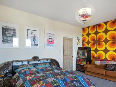 a bedroom with a bed and a couch at The St Bees Knees in St Bees