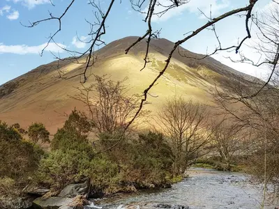 a hill with a river in front of a mountain at The St Bees Knees in St Bees