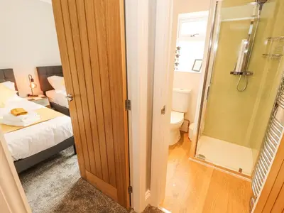a bathroom with a shower and a toilet in a room at Grace House in Wigton