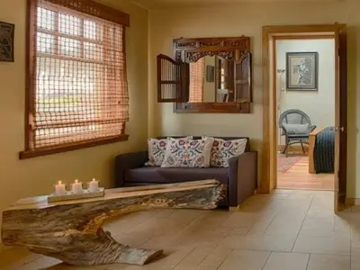 a living room with a couch and a log table at Lighthouse Studio Apartment in Portpatrick