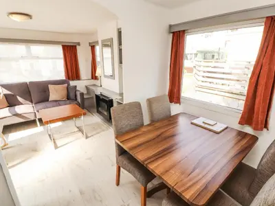 a living room with a wooden table and a couch at No 29 Wyndham Hall in Cockermouth