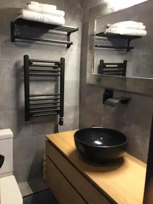 a bathroom with a black sink and a mirror at Lightkeepers Snug in Portpatrick