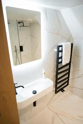 a bathroom with a sink and a mirror at Tucked Away in Keswick