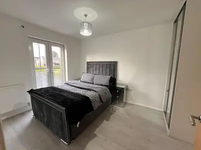 a bedroom with a bed in a room with a window at Z&Z Villa in Moffat