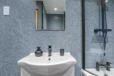 a bathroom with a white sink and a shower at The Cozy Atmosphere Lodge in Moffat