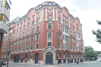 a large red brick building on a city street at 121 Princess Street in Moffat