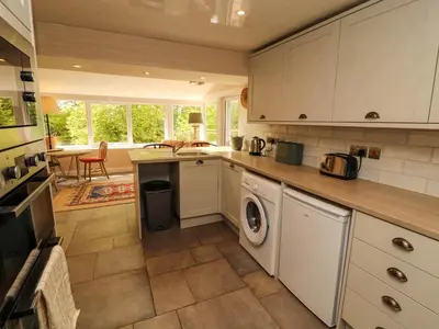 a kitchen with a washer and dryer at Kirkland Howe Cottage in Frizington