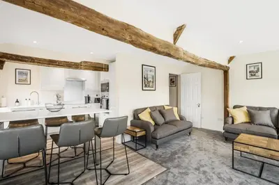 a living room with a couch and a table at Beautiful 3 bedroom cottage close to Goodwood ! in Moffat