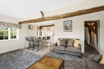 a living room with a couch and a table at Beautiful 3 bedroom cottage close to Goodwood ! in Moffat