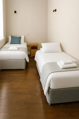 two beds sitting next to each other in a room at High living @ Ferguson Court in Carlisle