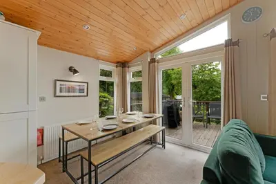 a living room with a table with glasses on it at Troutbeck Lodge in Bassenthwaite