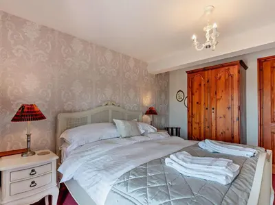 a bedroom with a bed and a table with a lamp at 2 Bed in Ireby 96088 in Ireby