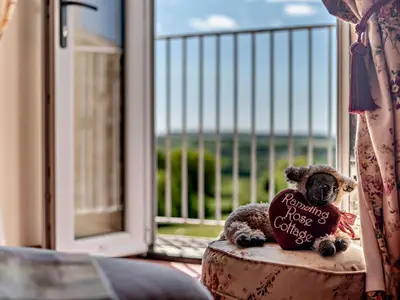 a teddy bear sitting on a pillow with a heart at 2 Bed in Ireby 96088 in Ireby