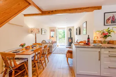 a kitchen and living room with a table and chairs at 2 Bed in Caldbeck oc-a32049 in Caldbeck