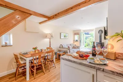 a kitchen and living room with a table and chairs at 2 Bed in Caldbeck oc-a32049 in Caldbeck
