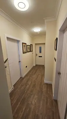 an empty hallway with two doors and wood floors at Harbour Havens Apartments in Moffat