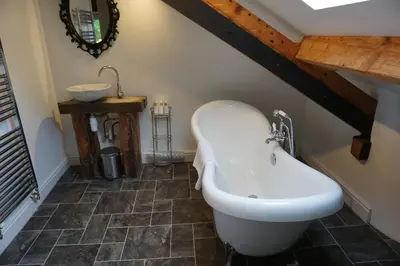 a bathroom with a sink and a bath tub at Lake View Country House and Self-catering Apartments in Grasmere