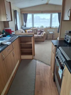 a kitchen and living room with a couch at The Coo Shed 94 in Newton Stewart