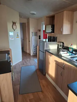 a kitchen with a refrigerator and a counter top at The Coo Shed 94 in Newton Stewart