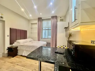 a bedroom with a bed and a desk in it at Collingham Road in Moffat
