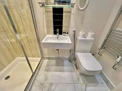 a bathroom with a sink and a toilet and a shower at Collingham Road in Moffat
