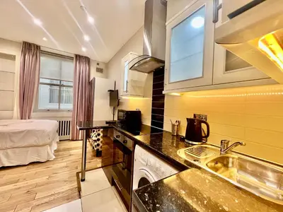 a kitchen with a sink and a bed in a room at Collingham Road in Moffat